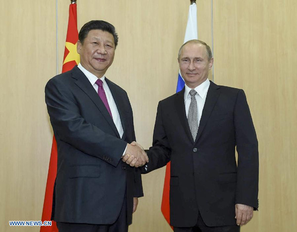 Chinese President Xi Jinping (L) shakes hands with his Russian counterpart Vladimir Putin in Ufa, Russia, July 8, 2015. (Xinhua/Li Xueren) Chinese President Xi Jinping (L) shakes hands with his Russian counterpart Vladimir Putin in Ufa, Russia, July 8, 2015. (Xinhua/Li Xueren)