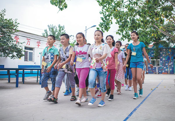 Students attend military training at Beijing's Dandelion School, a nonprofit institute for the children of migrant workers, in July. Zheng Liang / For China Daily Students attend military training at Beijing's Dandelion School, a nonprofit institute for the children of migrant workers, in July. Zheng Liang / For China Daily