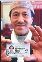 Tuladhar Ratna Kumar, a Nepalese citizen, shows his permanent resident's permit on Wednesday. (Photo/China Daily) Tuladhar Ratna Kumar, a Nepalese citizen, shows his permanent resident's permit on Wednesday. (Photo/China Daily)