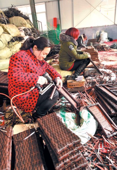 Women make camping stools in a workshop in Juancheng county, Shandong province. (Photo by Ju ChuanJiang/China Daily) Women make camping stools in a workshop in Juancheng county, Shandong province. (Photo by Ju ChuanJiang/China Daily)