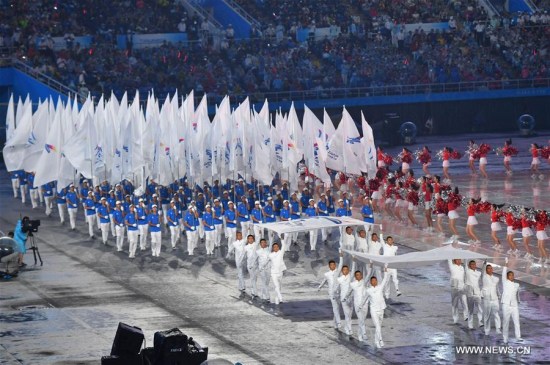 People bearing the flags of the 13th Chinese National Games parade into the stadium during the opening ceremony of the 13th Chinese National Games in north China's Tianjin Municipality, Aug. 27, 2017. (Xinhua/Zhu Zheng) People bearing the flags of the 13th Chinese National Games parade into the stadium during the opening ceremony of the 13th Chinese National Games in north China's Tianjin Municipality, Aug. 27, 2017. (Xinhua/Zhu Zheng)