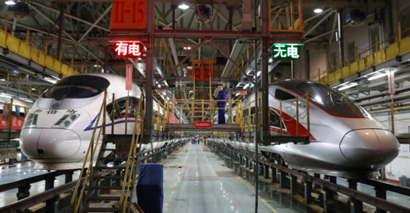 A Fuxing (rejuvenation) bullet train (right) and a Hexie (harmony) bullet train undergo maintenance at a depot late at night in Beijing earlier this month. (Photo by Zhu Xingxin/China Daily) A Fuxing (rejuvenation) bullet train (right) and a Hexie (harmony) bullet train undergo maintenance at a depot late at night in Beijing earlier this month. (Photo by Zhu Xingxin/China Daily)