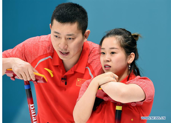 China's Ba Dexin (L) and Wang Rui react during the curling mixed doubles round robin session 5 against Becca Hamilton and Matt Hamilton from the United States at the 2018 PyeongChang Winter Olympic Games at the Gangneung Curling Centre in Gangneung, South Korea, on Feb. 10, 2018. (Xinhua/Ma Ping)
