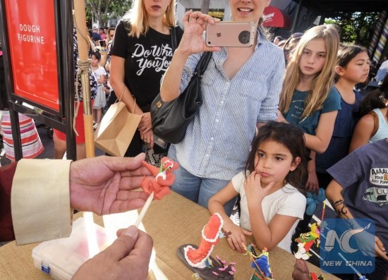 A dough figurine artist makes an animal figurine during a celebration for Chinese lunar new year at the Original Farmers Market in Los Angeles, the United States, Jan. 28, 2018. (Xinhua/Zhao Hanrong) A dough figurine artist makes an animal figurine during a celebration for Chinese lunar new year at the Original Farmers Market in Los Angeles, the United States, Jan. 28, 2018. (Xinhua/Zhao Hanrong)