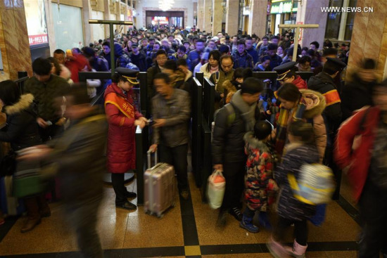 assengers wait in queue to check in at the Beijing Railway Station in Beijing, capital of China, Feb. 9, 2018.