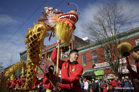 Participants perform dragon dance during the 45th Chinese New Year Parade in Vancouver, Canada, on Feb. 18, 2018. Thousands of participants paraded along the streets in Vancouver's Chinatown Sunday to celebrate the Year of the Dog, attracting over 100,000 spectators. (Xinhua/Liang Sen) Participants perform dragon dance during the 45th Chinese New Year Parade in Vancouver, Canada, on Feb. 18, 2018. Thousands of participants paraded along the streets in Vancouver's Chinatown Sunday to celebrate the Year of the Dog, attracting over 100,000 spectators. (Xinhua/Liang Sen)
