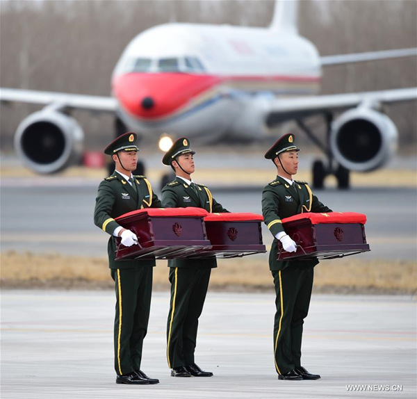 Soldiers carry coffins containing remains of the Chinese People's Volunteers (CPV) killed in the Korean War, at the Taoxian International Airport in Shenyang, capital of northeast China's Liaoning Province, March 28, 2018. The remains of 20 Chinese soldiers killed in the 1950-53 Korean War were returned to China from the Republic of Korea (ROK) Wednesday. A ceremony was held at the airport to welcome back the remains. (Xinhua/Yang Qing)
