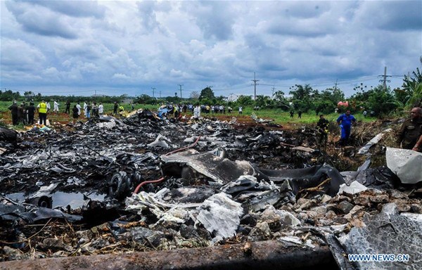 Rescuers work at the site where an airplane of Cuban airline