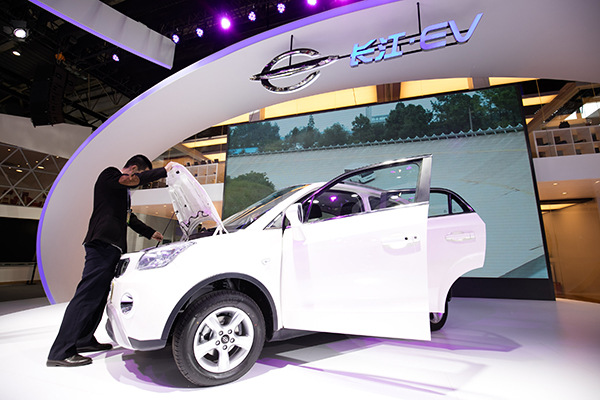 A visitor checks a new-energy car at the Beijing auto show in May. (Photo/China Daily) A visitor checks a new-energy car at the Beijing auto show in May. (Photo/China Daily)