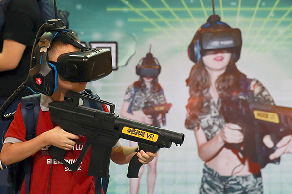 A boy tries VR games at an urban science festival in Beijing. (Photo/China Daily) A boy tries VR games at an urban science festival in Beijing. (Photo/China Daily)