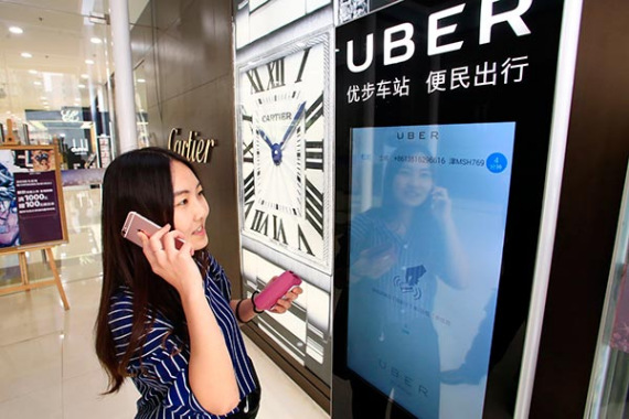 A woman uses Uber Technologies Inc's car-hailing service via an electronic screen in Tianjin.(Photo/Provided to China Daily) A woman uses Uber Technologies Inc's car-hailing service via an electronic screen in Tianjin.(Photo/Provided to China Daily)