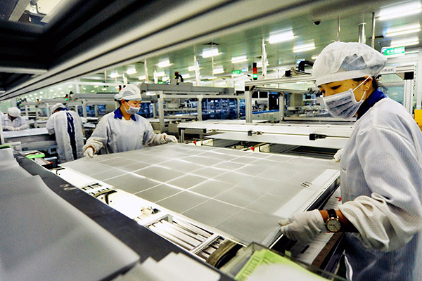 Two women operate on a production line of a solar panel making company in Shangrao, Jiangxi province. (Photo/China Daily) Two women operate on a production line of a solar panel making company in Shangrao, Jiangxi province. (Photo/China Daily)