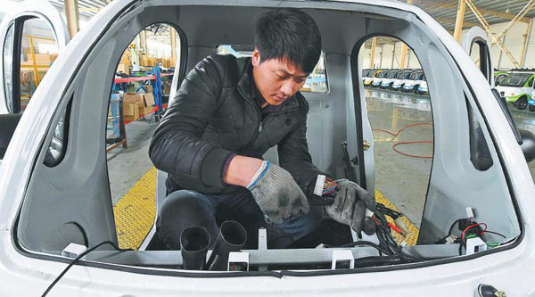 A worker assembles parts in an electric car on a production line in Weifang, Shandong province. (Photo by Ao Tu/For China Daily) A worker assembles parts in an electric car on a production line in Weifang, Shandong province. (Photo by Ao Tu/For China Daily)