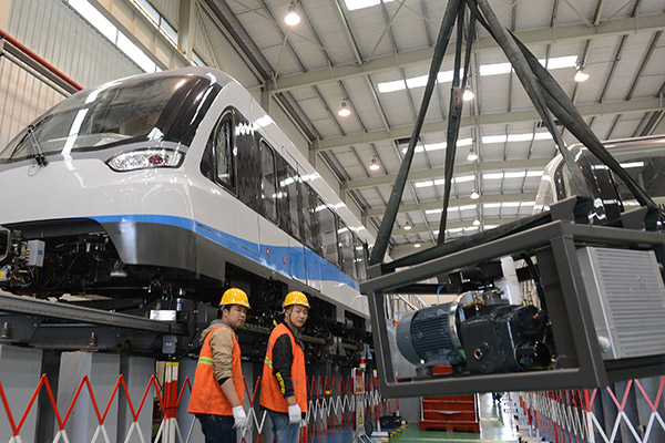 Workers at a magnetic levitation train manufacturing company in Zhuzhou, Hunan province. (Xu Xing/for China Daily) Workers at a magnetic levitation train manufacturing company in Zhuzhou, Hunan province. (Xu Xing/for China Daily)