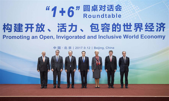 China's Premier Li Keqiang and heads of major international economic institutions pose for pictures before the