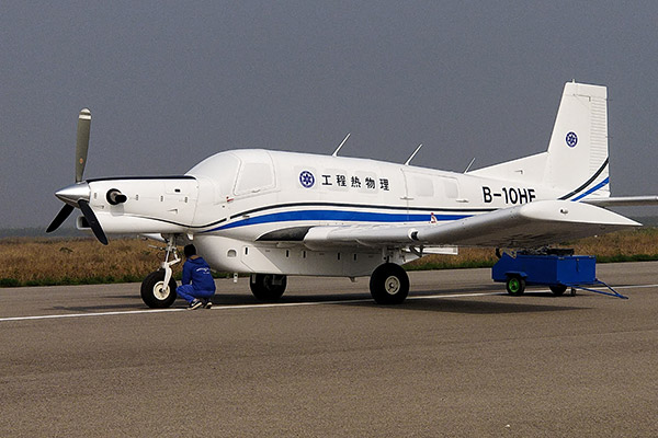 A technician checks an AT200, the world's largest transportation drone with a ton-level capacity, in Pucheng county, Shaanxi province. (Photo/Xinhua) A technician checks an AT200, the world's largest transportation drone with a ton-level capacity, in Pucheng county, Shaanxi province. (Photo/Xinhua)