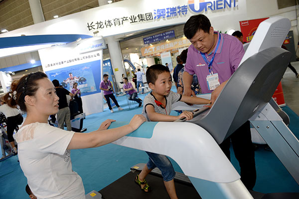 A boy tries an automated treadmill at a sports exhibition in Xi'an, capital of Northwest China's Shaanxi Province. (Photo/Xinhua) A boy tries an automated treadmill at a sports exhibition in Xi'an, capital of Northwest China's Shaanxi Province. (Photo/Xinhua)