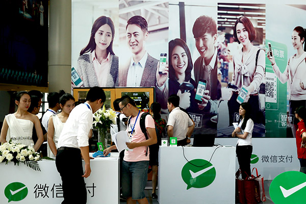 Consumers use WeChat Pay at an exibition in Fuzhou, Fujian province. (Photo/for China Daily) Consumers use WeChat Pay at an exibition in Fuzhou, Fujian province. (Photo/for China Daily)