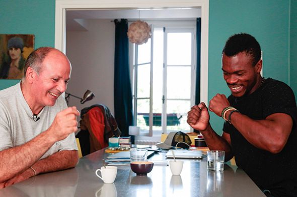 Cameroonian refugee Emilien Atanga (right), 24, talks with Joel Elbaz, 57, the host who lent him an apartment through U.S. home-sharing website Airbnb on July 18, 2017, in Paris.(Photo provided to China Daily) Cameroonian refugee Emilien Atanga (right), 24, talks with Joel Elbaz, 57, the host who lent him an apartment through U.S. home-sharing website Airbnb on July 18, 2017, in Paris.(Photo provided to China Daily)