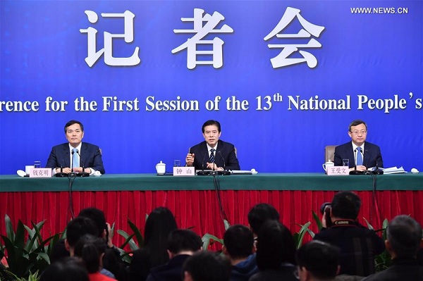 Chinese Minister of Commerce Zhong Shan (C), Vice Minister of Commerce and Deputy China International Trade Representative Wang Shouwen (R), and Vice Minister of Commerce Qian Keming attend a press conference on opening up on all fronts and promoting high quality development of commercial business on the sidelines of the first session of the 13th National People's Congress in Beijing, capital of China, March 11, 2018. (Xinhua/Li Xin) Chinese Minister of Commerce Zhong Shan (C), Vice Minister of Commerce and Deputy China International Trade Representative Wang Shouwen (R), and Vice Minister of Commerce Qian Keming attend a press conference on opening up on all fronts and promoting high quality development of commercial business on the sidelines of the first session of the 13th National People's Congress in Beijing, capital of China, March 11, 2018. (Xinhua/Li Xin)
