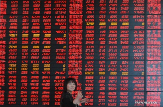 An investor looks through stock information at a trading hall of a securities firm in Fuyang City, east China's Anhui Province, April 21, 2015. (Photo/Xinhua) An investor looks through stock information at a trading hall of a securities firm in Fuyang City, east China's Anhui Province, April 21, 2015. (Photo/Xinhua)