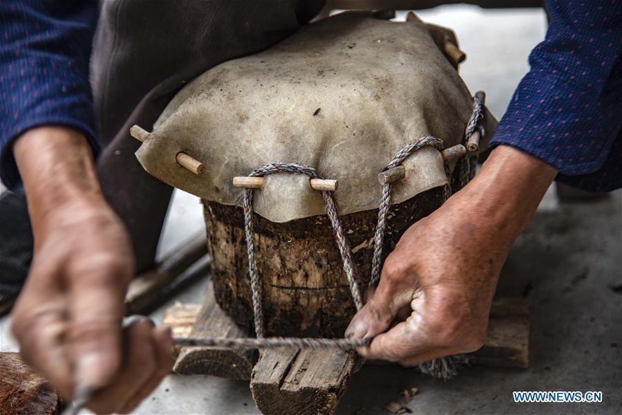 Wu Kaixue makes a Dingtang drum at his courtyard in Longtan Village, Shennongjia of central China\'s Hubei Province, May 21, 2018. Wu Kaixue, who is 75 years old, began to learn the making of Dingtang drums when he was 13. The making of Dingtang drums needs natural resources from the Shennongjia forest and also requires high standard of techniques. Wu makes 100 plus drums in a year and his fame has spread far away. (Xinhua/Du Huaju)