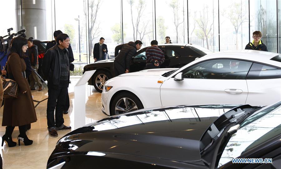 People visit an exhibition center for imported cars at the China (Shanghai) Pilot Free Trade Zone in Shanghai, east China, Feb. 15, 2015. This year marks the 40th anniversary of China\'s starting to implement reform and opening up policy. (Xinhua/Fang Zhe)