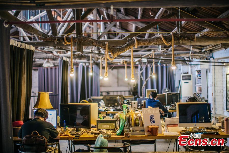 Three young people have transformed an abandoned room of a walking tractor factory into a modern office space for their cultural creations in Nanning City, South China’s Guangxi Zhuang Autonomous Region. Xu Xiaomao, Ouyang Dinghua and Wei Ning rented the space in April 2015 and renovated it for their startup in video and music production. The closed tractor factory was built in 1956 of the former Soviet style. (Photo: China News Service/Liu Yujun)