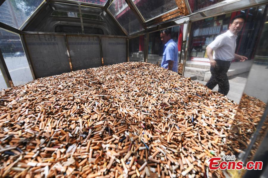 Cigarette butts collected by sanitary workers in downtown Lanzhou City, Gansu Province are being displayed in an activity to raise public awareness of environmental protection, May 24, 2018. (Photo: China News Service/Yang Yanmin)