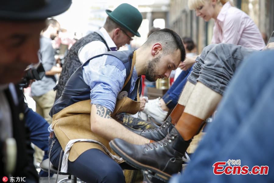 The first European competition of shoe cleaning is held in the historical gallery of Saint Hubert in Brussels, Belgium, May 26, 2018. About 10 shiners from different European countries free polished shoes to customers in this event. (Photo/IC)