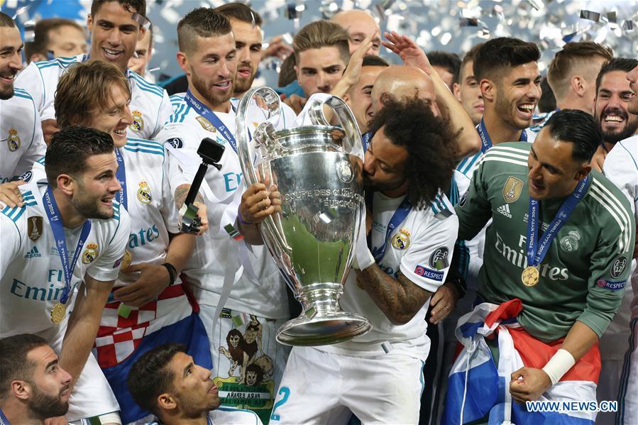 Marcelo (C) of Real Madrid kisses the trophy after the UEFA Champions League final match between Liverpool and Real Madrid in Kiev, Ukraine on May 26, 2018. Real Madrid claimed the title with 3-1. (Xinhua/Sergey)