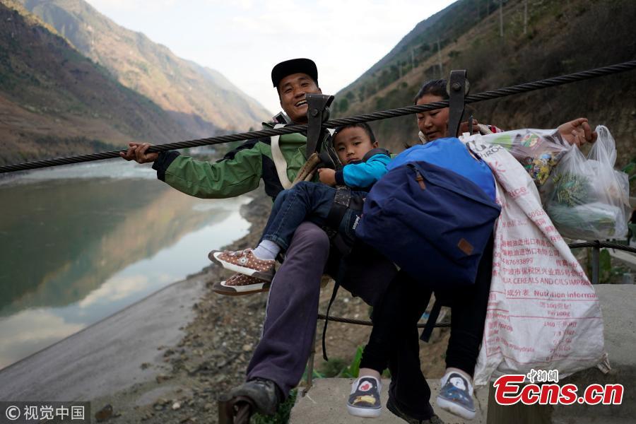 Villagers are seen crossing the river with a zipline in a village in Nujiang Lisu Autonomous Prefecture in Southwest China’s Yunnan Province. Villagers have to use a zipline to cross the raging river. (Photo/VCG)