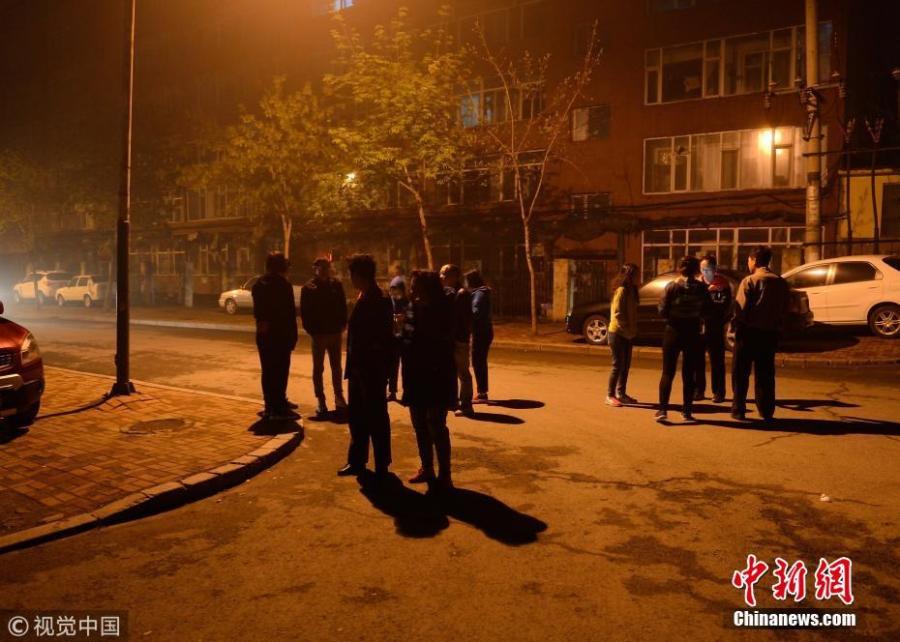 People stand outside buildings following a magnitude of 5.7 earthquake in Songyuan City, Jilin Province, May 28, 2018. (Photo/VCG)
