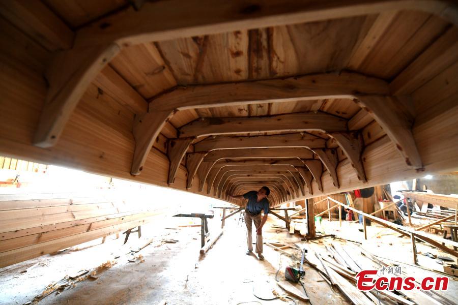 A man works in a dragon boat-making factory in Fangzhuang Village, Minhou County, East China’s Fujian Province, May 30, 2018. The village has a 700-year history of dragon-boat making. As fewer young people work to inherit the skills of the traditional craft, the village is now home to just four factories still using ancient simple tools to make the handmade boats. The Dragon Boat Festival is celebrated on the fifth day of the fifth month of the Chinese lunar calendar and falls on June 18 this year. (Photo: China News Service/Wang Dongming)