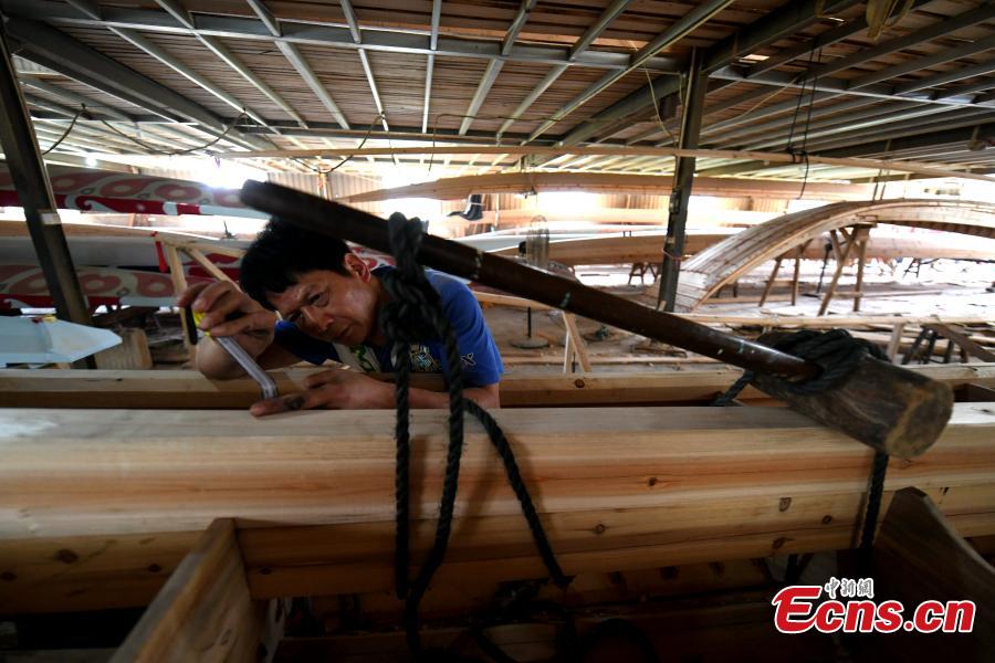 A man works in a dragon boat-making factory in Fangzhuang Village, Minhou County, East China’s Fujian Province, May 30, 2018. The village has a 700-year history of dragon-boat making. As fewer young people work to inherit the skills of the traditional craft, the village is now home to just four factories still using ancient simple tools to make the handmade boats. The Dragon Boat Festival is celebrated on the fifth day of the fifth month of the Chinese lunar calendar and falls on June 18 this year. (Photo: China News Service/Wang Dongming)