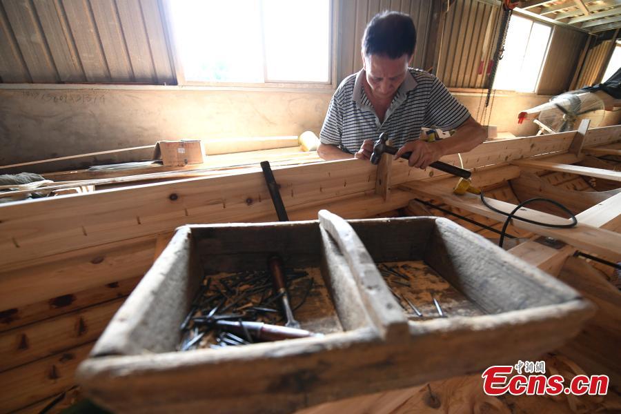 A man works in a dragon boat-making factory in Fangzhuang Village, Minhou County, East China’s Fujian Province, May 30, 2018. The village has a 700-year history of dragon-boat making. As fewer young people work to inherit the skills of the traditional craft, the village is now home to just four factories still using ancient simple tools to make the handmade boats. The Dragon Boat Festival is celebrated on the fifth day of the fifth month of the Chinese lunar calendar and falls on June 18 this year. (Photo: China News Service/Wang Dongming)