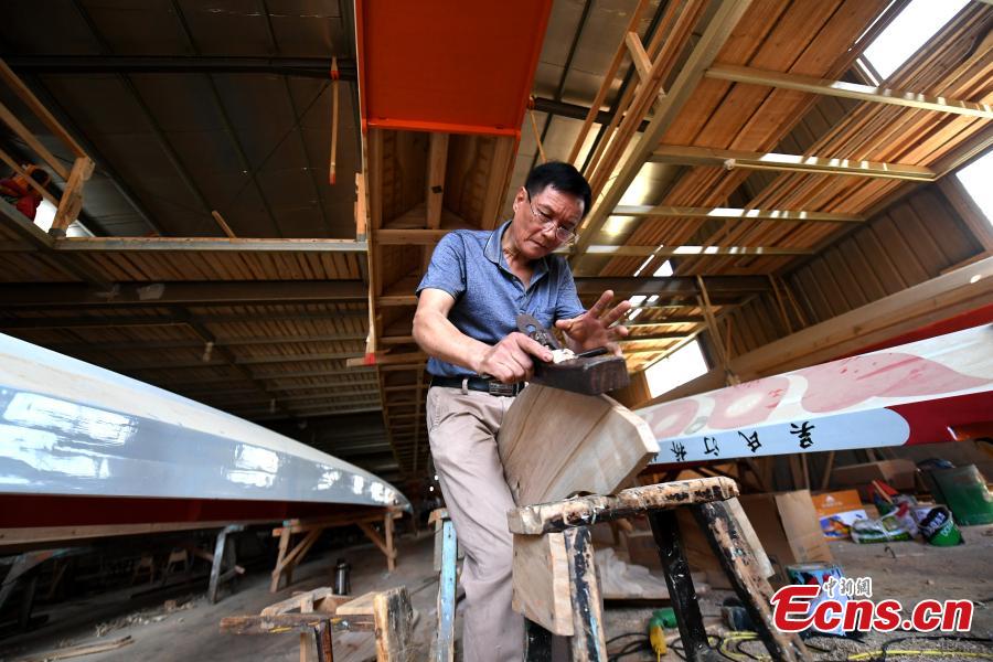 Fang Shaofang works in a dragon boat-making factory in Fangzhuang Village, Minhou County, East China’s Fujian Province, May 30, 2018. The village has a 700-year history of dragon-boat making. As fewer young people work to inherit the skills of the traditional craft, the village is now home to just four factories still using ancient simple tools to make the handmade boats. The Dragon Boat Festival is celebrated on the fifth day of the fifth month of the Chinese lunar calendar and falls on June 18 this year. (Photo: China News Service/Wang Dongming)
