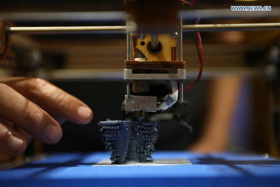A 3D printer processes a ghost net during the exhibition \