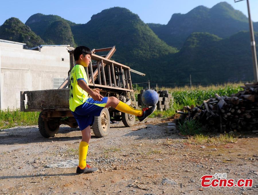 Wei Yuncheng plays football after school near his home in Liuye Township, Dahua Yao Autonomous County, South China’s Guangxi Zhuang Autonomous Region. Wei, a member of the Liuye Central Elementary School boys football team, said his dream is to one day leave his mountain home to explore the outside world by playing football well. The mountainous county, with a population of 400,000 people, is one the poorest in the region. (Photo: China News Service/Jiang Xuelin)
