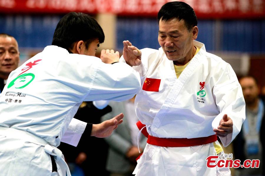 Two Tai Chi participants compete in a martial arts contest during the 17th Qinghai Province Games in Xining City, Northwest China’s Qinghai Province, June 3, 2018. (Photo: China News Service/Chen Tianfu)