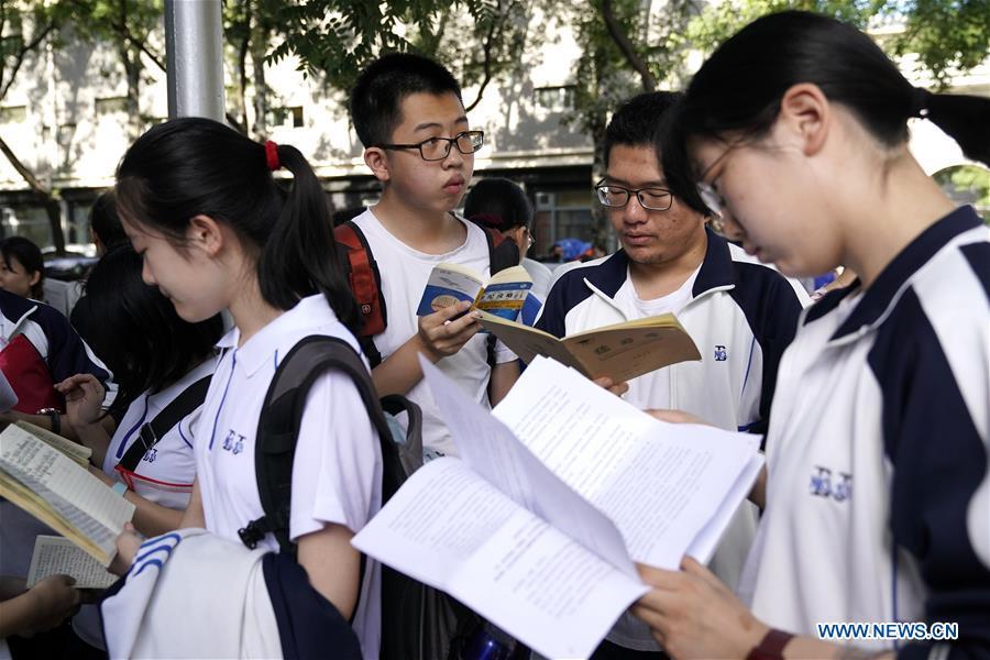 Examinees review before the exam at the Beijing No. 4 Middle School in Beijing, capital of China, June 7, 2018. About 9.75 million students have registered for the national college entrance examination, which takes place from June 7 to 8. (Xinhua/Shen Bohan)