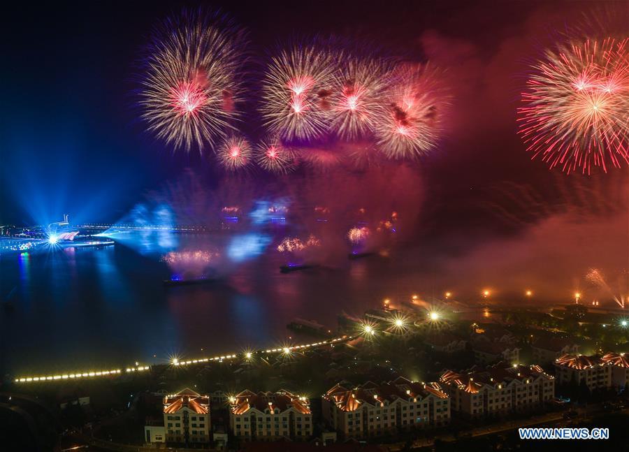 A lights and fireworks show takes place in Qingdao, the host city of the 18th Shanghai Cooperation Organization (SCO) summit, in east China\'s Shandong Province, June 9, 2018. (Xinhua/Jiang Kehong)
