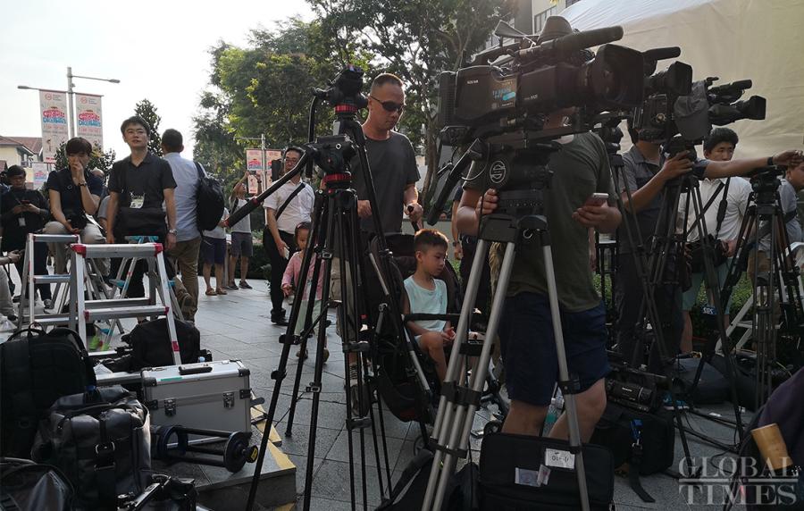 Journalists prepare outside the St. Regis hotel where DPRK leader Kim Jong-un has stayed in Singapore on Sunday. (Photo: Yang Sheng/GT)