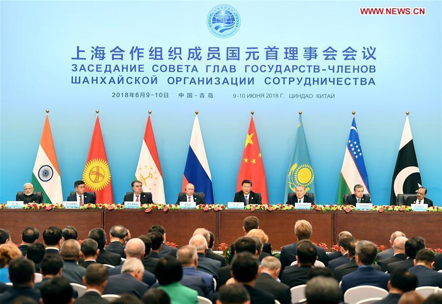 Xi Jinping, president of China that holds the rotating presidency of the Shanghai Cooperation Organization (SCO), addresses a joint press conference at the SCO summit in Qingdao, east China\'s Shandong Province, June 10, 2018. Indian Prime Minister Narendra Modi, Kazakh President Nursultan Nazarbayev, Kyrgyz President Sooronbay Jeenbekov, Pakistani President Mamnoon Hussain, Russian President Vladimir Putin, Tajik President Emomali Rahmon and Uzbek President Shavkat Mirziyoyev also attended the press conference. (Xinhua/Yan Yan)