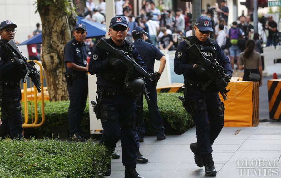 Singaporean police on patrol to ensure the security outside the St. Regis hotel where DPRK leader Kim Jong-un has stayed on Sunday. (Photo: Yang Sheng/GT)