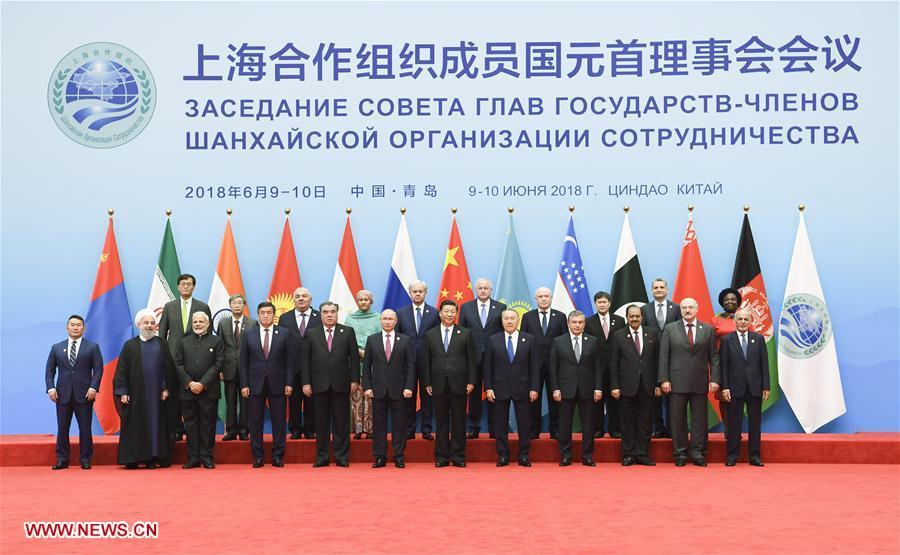 Chinese President Xi Jinping (6th R, front) poses for a group photo with other leaders and guests ahead of the 18th Meeting of the Council of Heads of Member States of the Shanghai Cooperation Organization (SCO) in Qingdao, east China\'s Shandong Province, June 10, 2018. Xi chaired the meeting and delivered a speech. (Xinhua/Gao Jie)