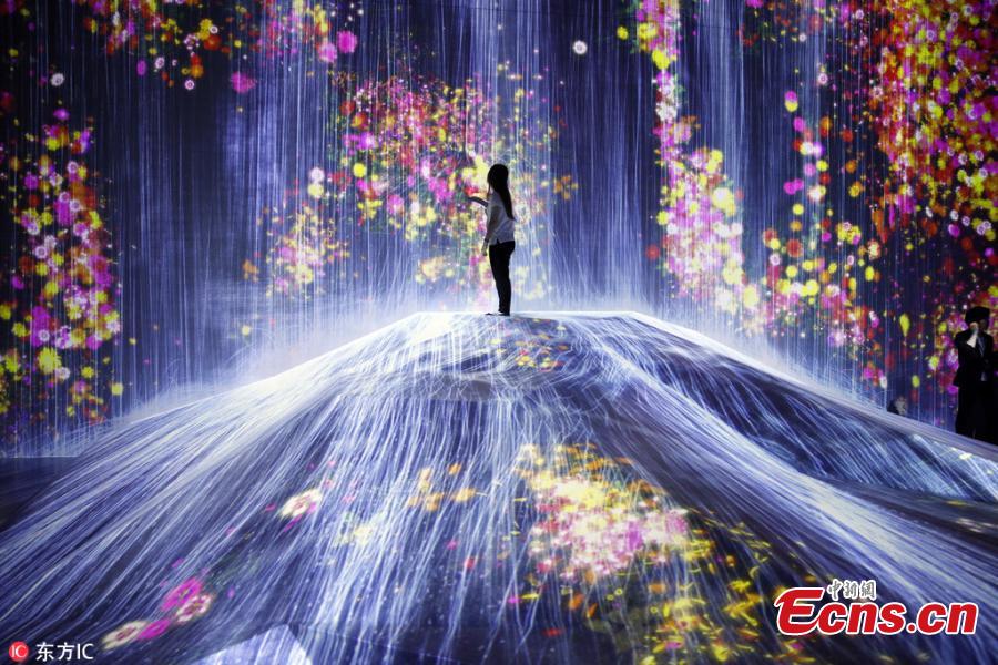 The flower-filled waterfall is the work of Japanese collective teamLab, known internationally for their innovative \