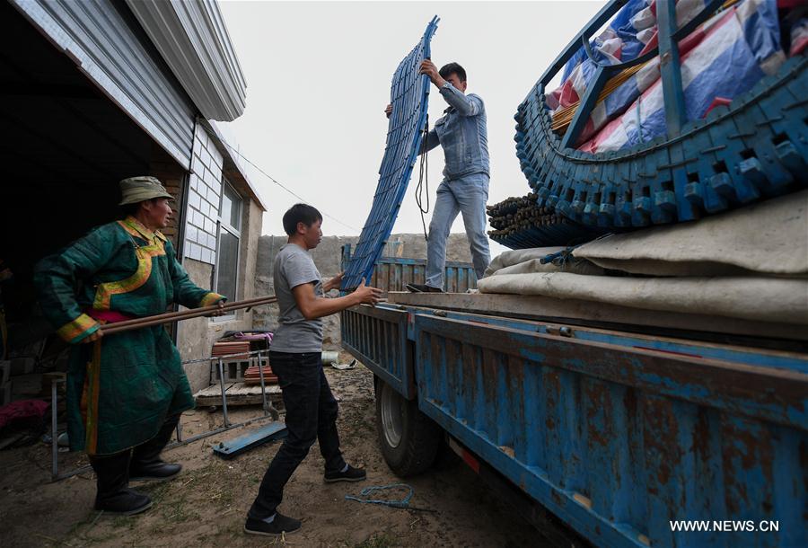 Erden uploads living households on truck with the help of relatives before transfer at the Ar Horqin Banner in Chifeng City, north China\'s Inner Mongolia Autonomous Region, June 4, 2018. June 5 was the day for Erden\'s family to move their cattle to a summer pasture, about 40 kilometers away from their family. It is a tradition for nomadic herdsmen spending their lives following the water and pasture. The transfer provides cattle and sheep abundant food and enables the grassland to renew itself. Erden and his sister drive their trucks loaded with living households and lead over 80 cattle towards the summer pasture. After 12 hours\' arduous journey, they arrived at their destination and prepared to set up yurt. They will stay here for a whole summer and return to their family in September. (Xinhua/Peng Yuan)