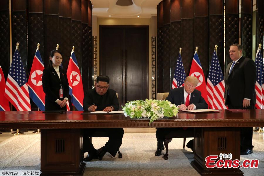 U.S. President Donald Trump (R) and top leader of the Democratic People\'s Republic of Korea (DPRK) Kim Jong Un sign documents that acknowledge the progress of the talks and pledge to keep momentum going, after their summit at the Capella Hotel on Sentosa island in Singapore, June 12, 2018. Trump said it is a \