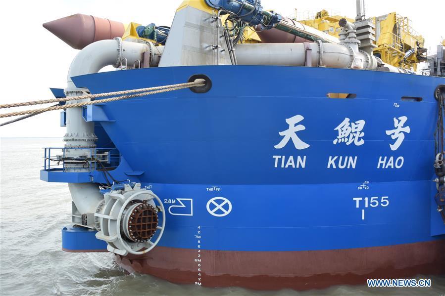 Tian Kun Hao, a Chinese-built dredging vessel, the largest of its kind in Asia, berths at a port in Qidong City, east China\'s Jiangsu Province, June 7, 2018. Tian Kun Hao, constructed by Tianjin Dredging Co. Ltd., a subsidiary of China Communication Construction Co., Ltd. (CCCC), finished its first sea trial. The 140-meter-long vessel, with the designed capacity to dredge 6,000 cubic meters per hour, can dig as deep as 35 meters under the sea floor. (Xinhua/Mao Zhenhua)